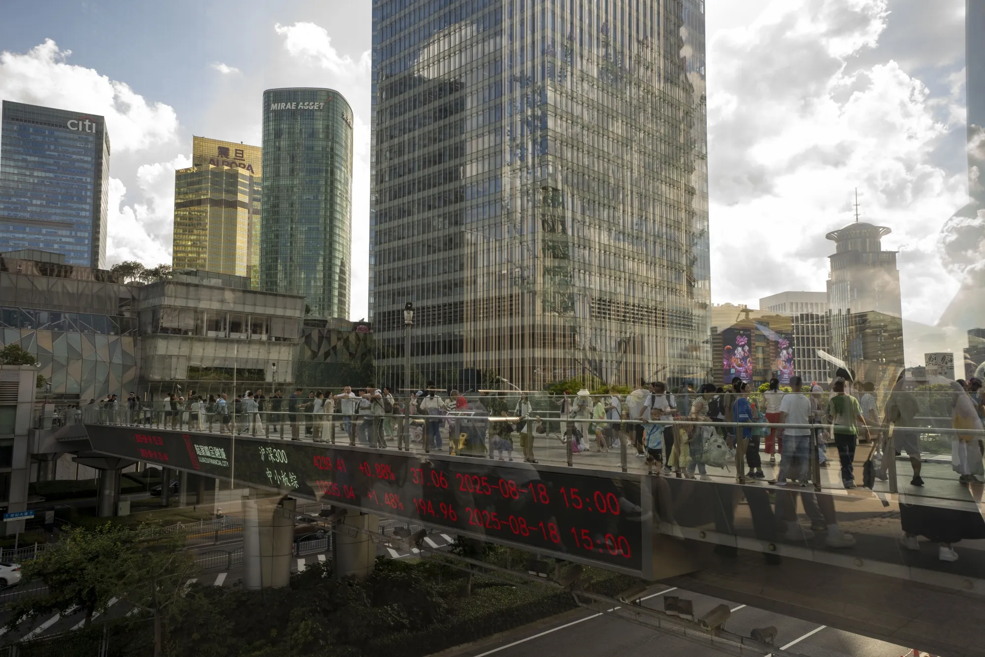 An electronic ticker displays stock figures in Pudong's Lujiazui Financial District in Shanghai.