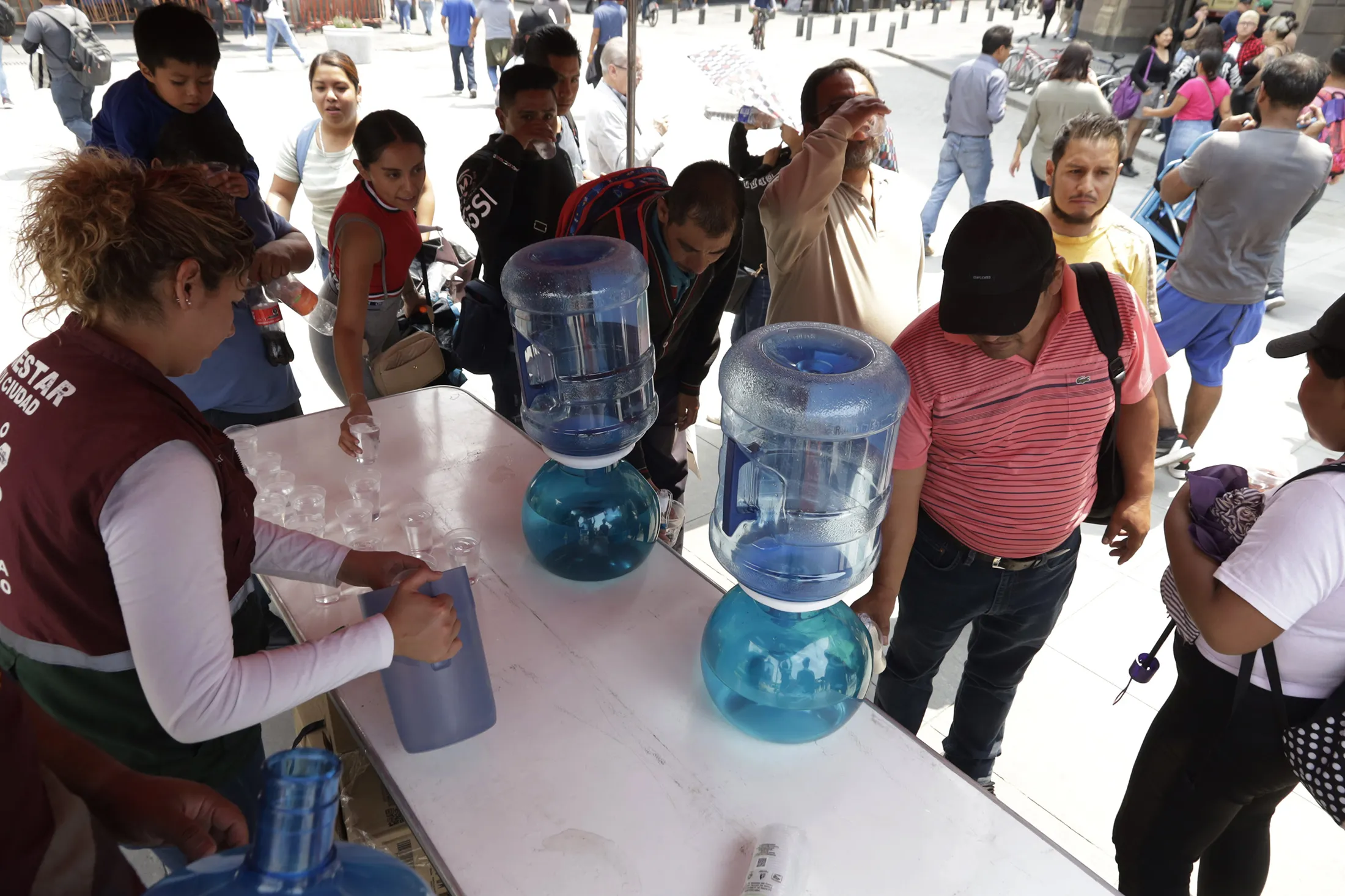 Government workers offer water to pedestrians&nbsp;because of the high temperatures in Mexico City on May 16.&nbsp;