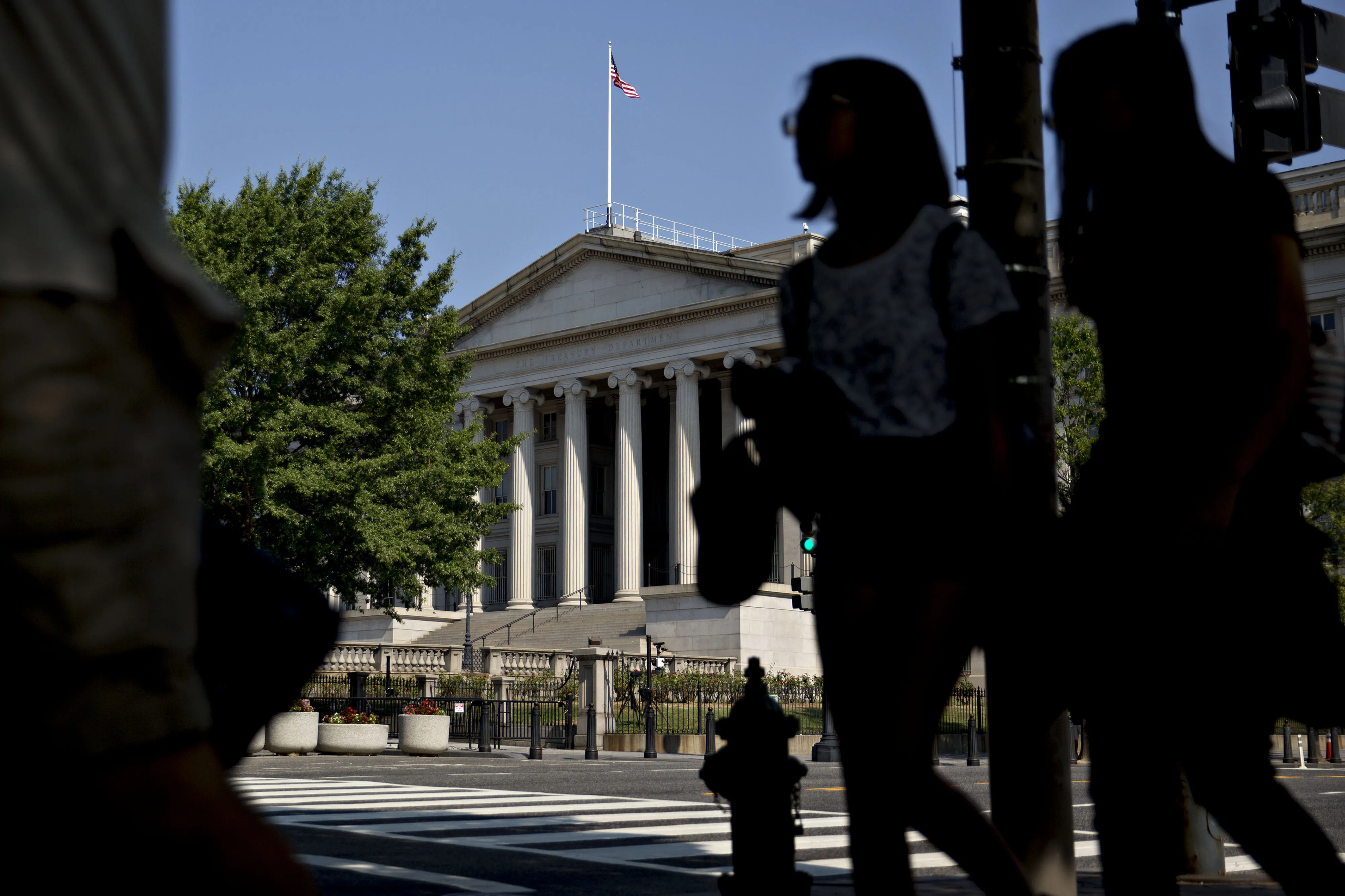 Pedestrians walk near the U.S. Treasury building in Washington.