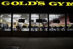 People work out at a Gold’s Gym on March 16.