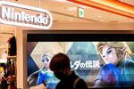 A person walks past a screen displaying characters from the Nintendo game &quot;The Legend of Zelda&quot; at a store&nbsp;in Tokyo.