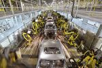 Robots work on the welding line at a Beijing Hyundai Motor Co. plant in Beijing on March 15