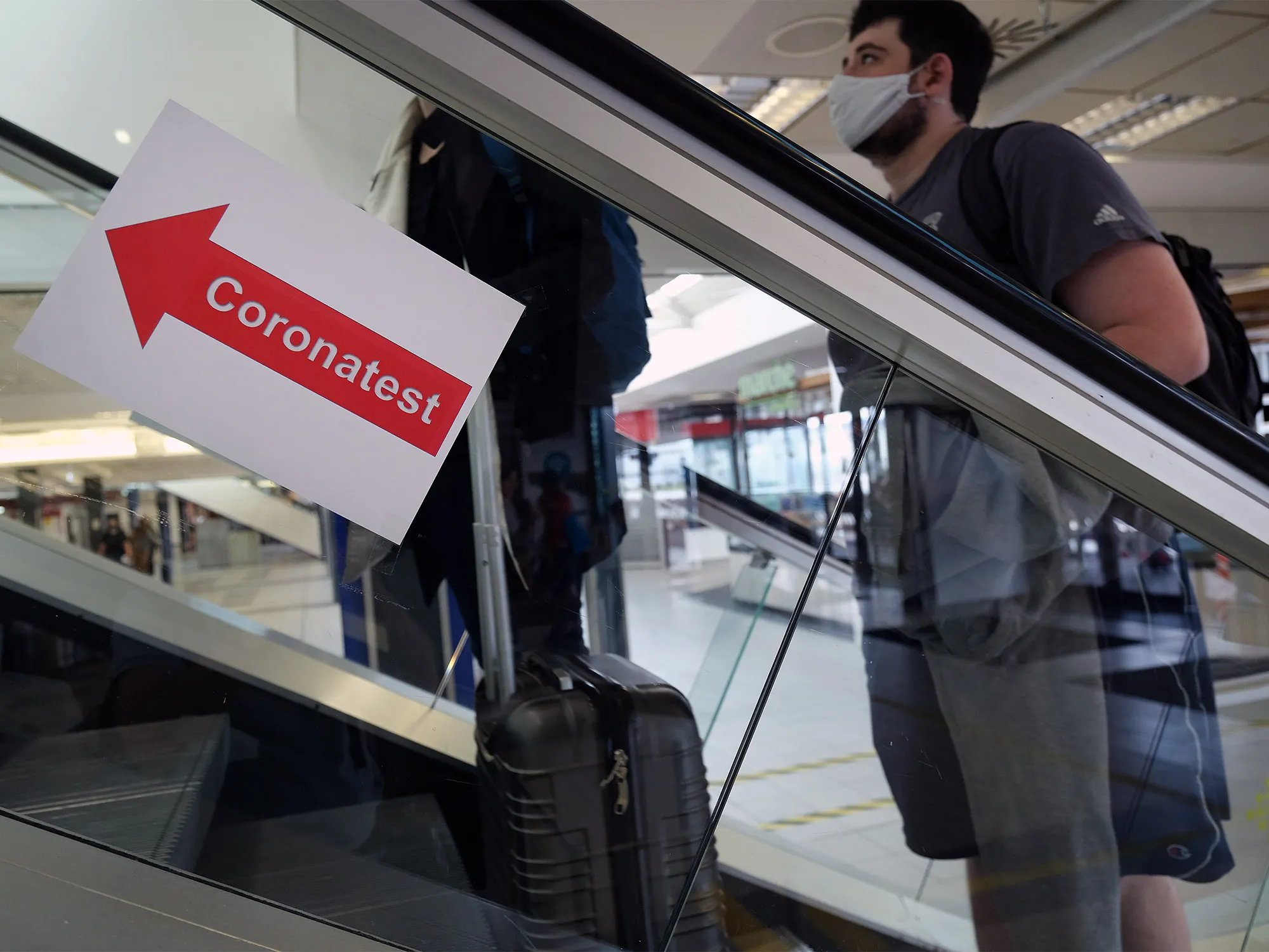A sign directs travelers to a coronavirus testing station at Schoenefeld Airport near Berlin on Aug.&nbsp;4.