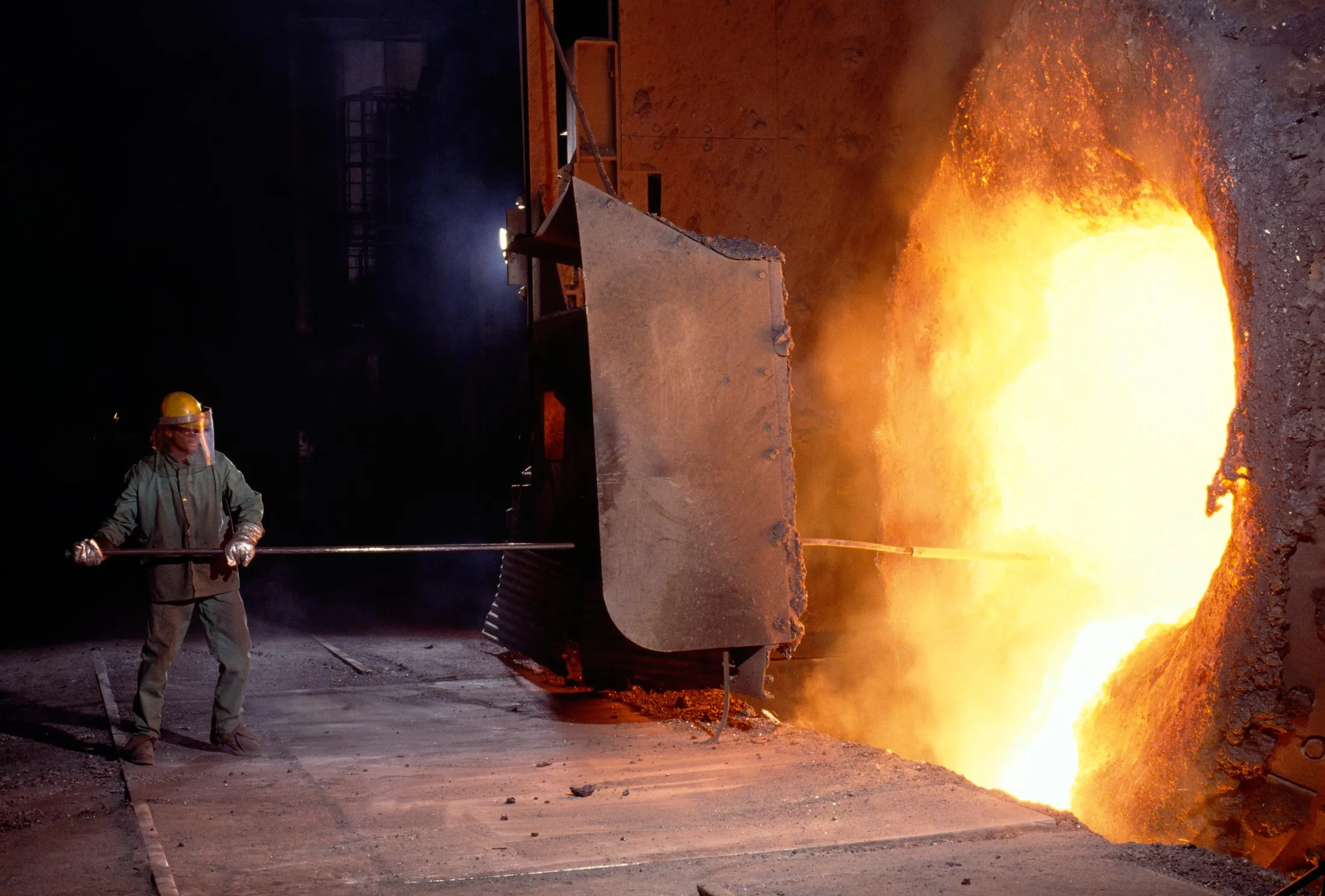 A worker taps a blast furnace in the U.S.
