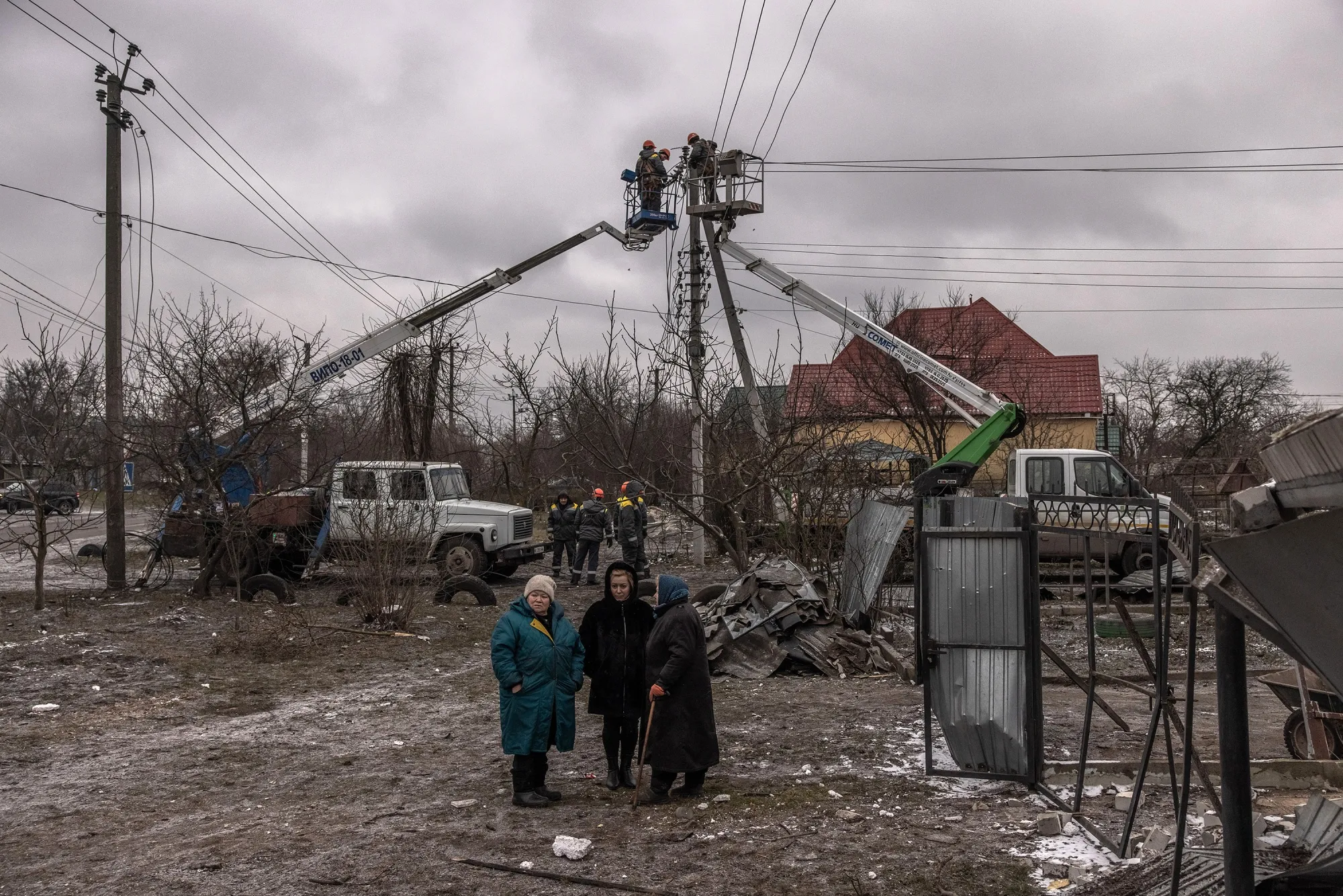 Workers repair electricity cables following Russian missile attacks near Kyiv, Ukraine, on Jan. 26.