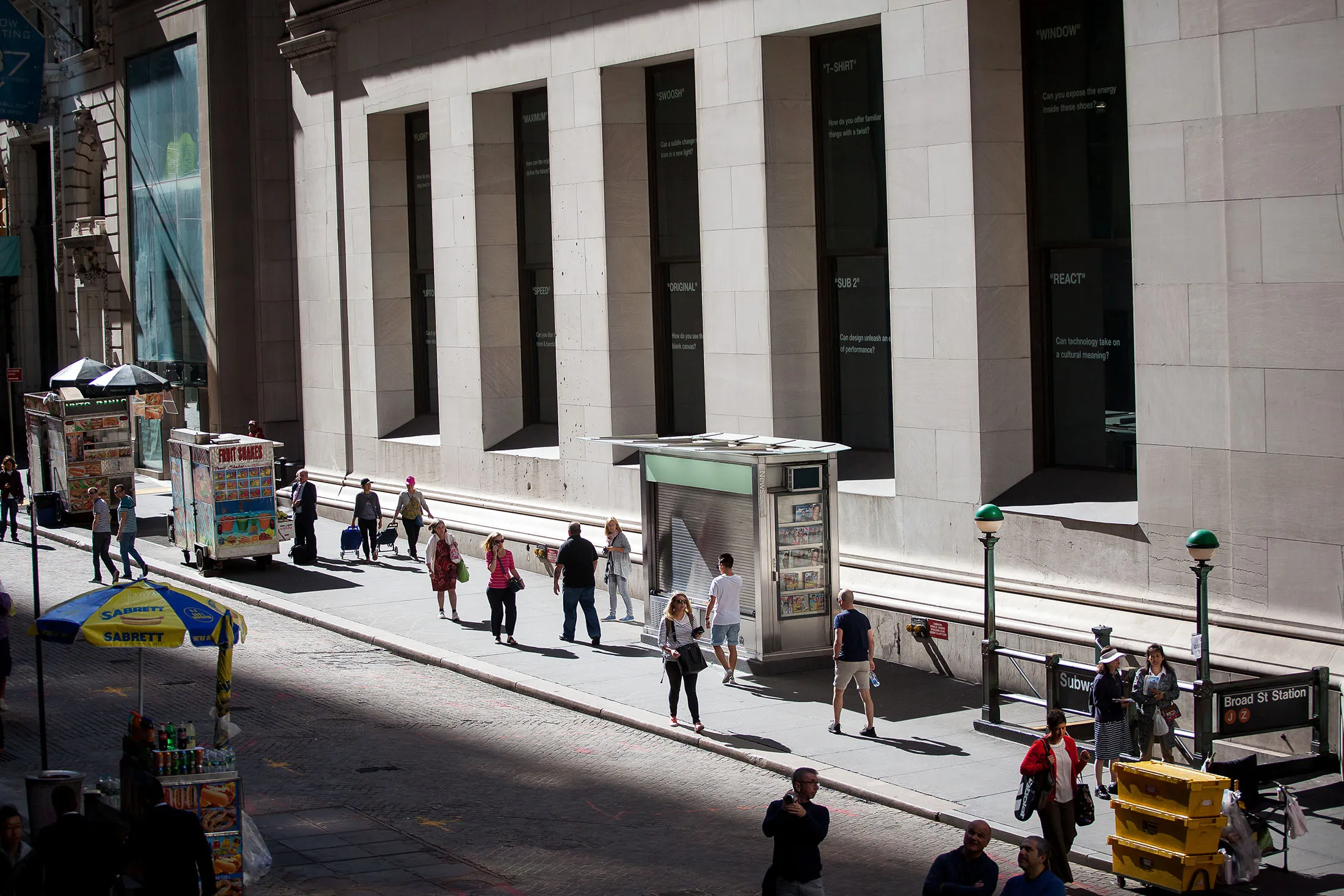 Pedestrians walk along Wall Street near the New York Stock Exchange (NYSE) in New York, U.S., on Friday, Sept. 8, 2017. The dollar fell to the weakest in more than two years, while stocks were mixed as natural disasters damped expectations for another U.S. rate increase this year.
