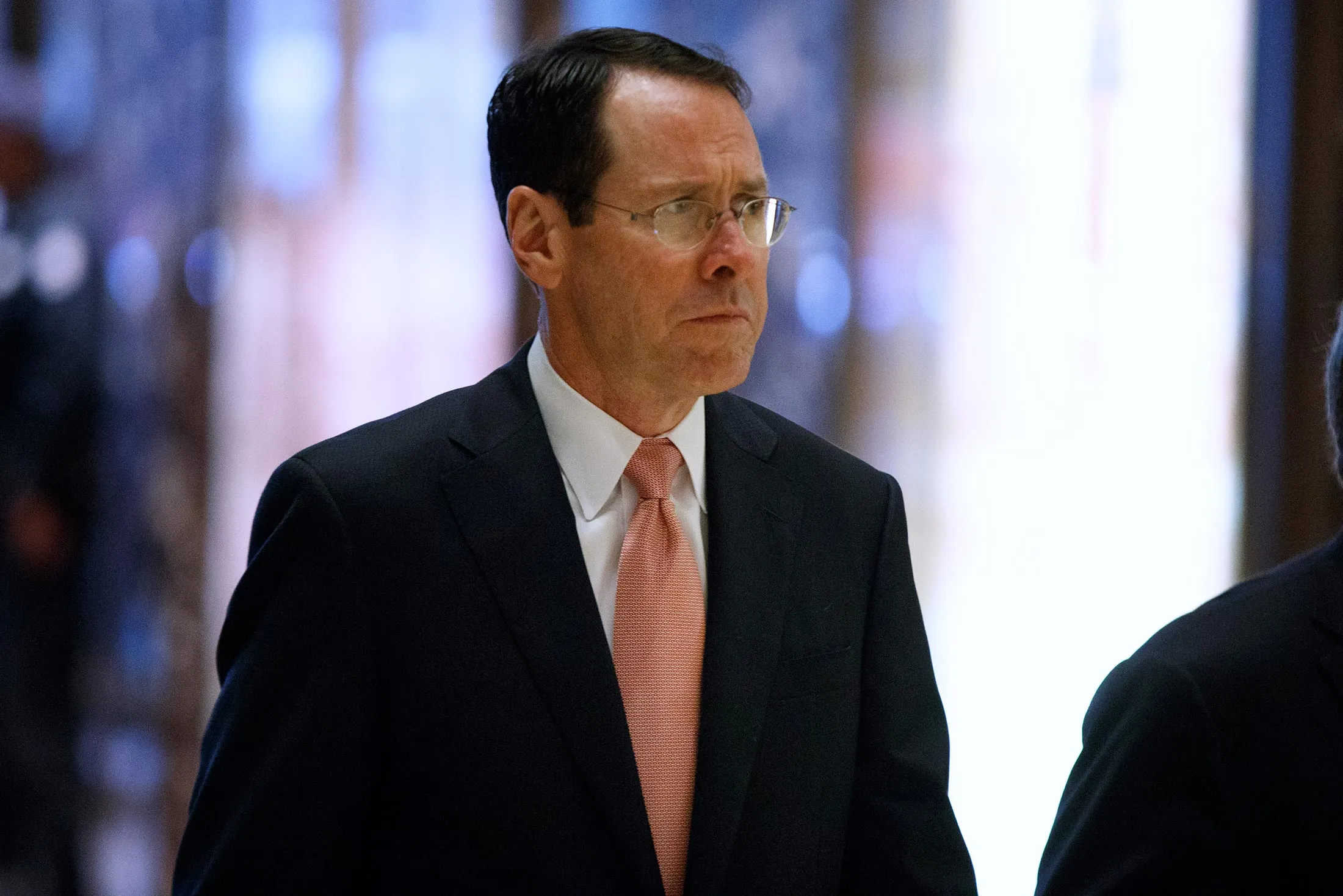 AT&amp;T CEO Randall Stephenson arrives in the lobby of Trump Tower in New York, on Jan. 12, for a meeting with President-elect Donald Trump.
