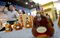 Visitors walk past counterfeit liquor on