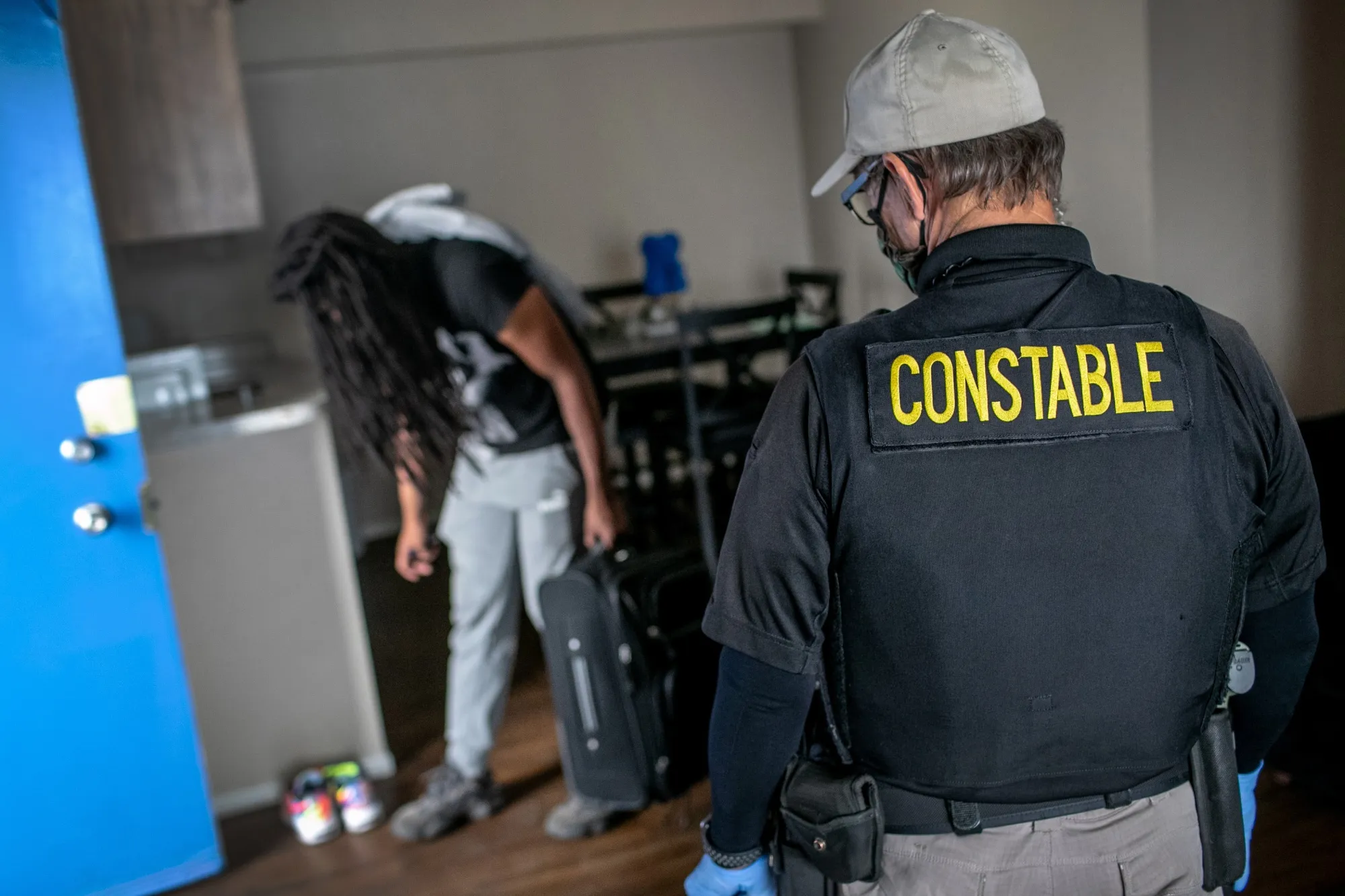 Maricopa County constable Lenny McCloskey evicts an apartment resident for non-payment of rent in Phoenix in October.&nbsp;