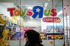 A pedestrian passes in front of a Toys R Us Inc. retail store in New York, U.S.