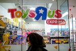 A pedestrian passes in front of a Toys R Us Inc. retail store in New York, U.S.