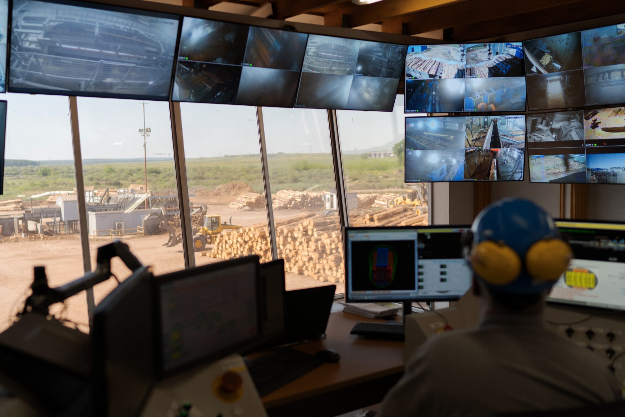 A worker watches the security footage as lumber is cut at the Arboreal sawmill in Tacuarembo, Uruguay, on Thursday, October 28, 2021