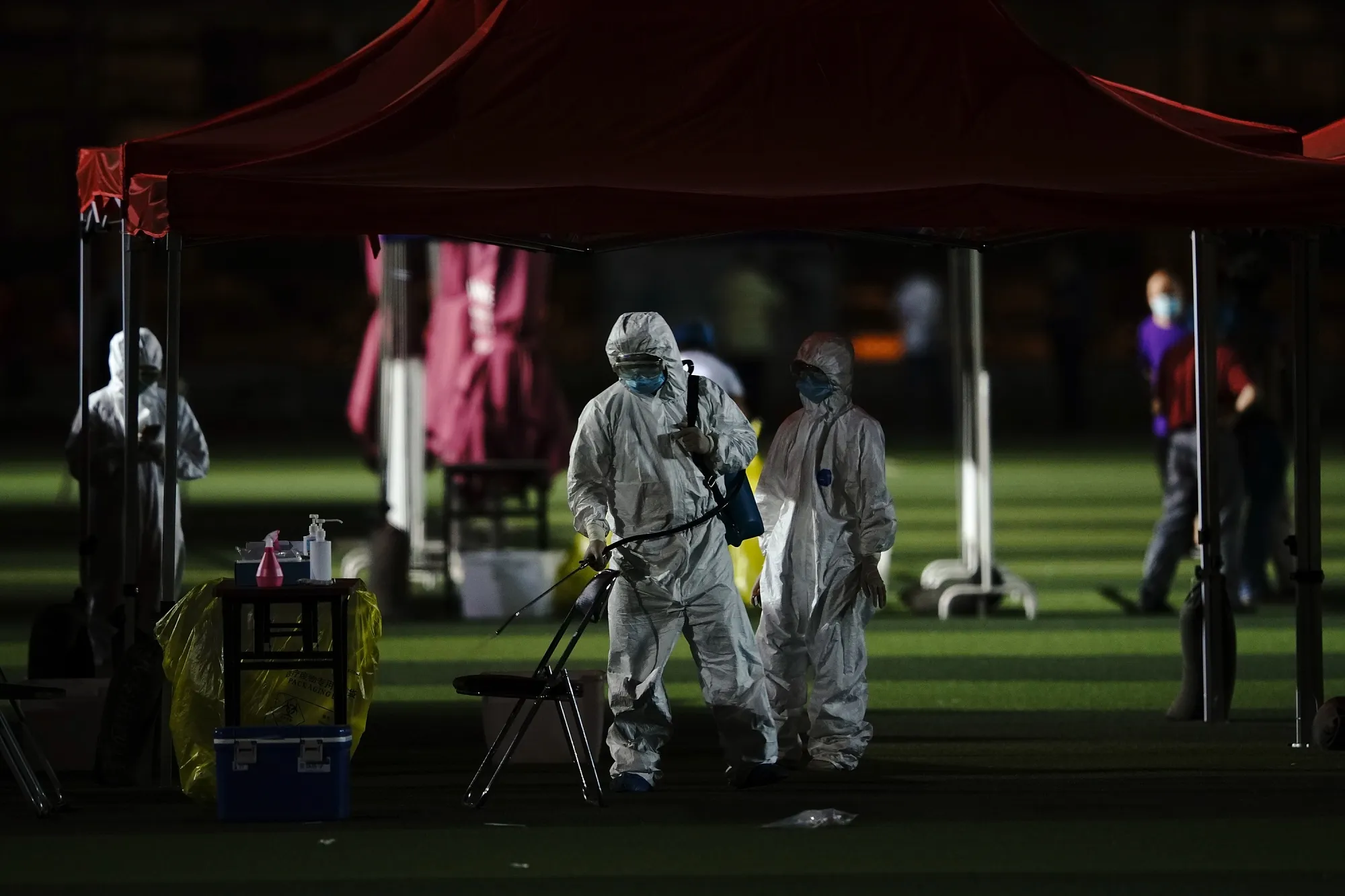 A medical worker disinfects the coronavirus testing site in Beijing on June 17.