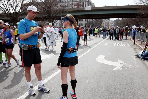 A runner uses his phone following the explosion of two bombs during the 117th Boston Marathon