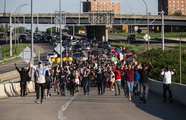 Protesters march up a highway off-ramp on May 28, 2020.
