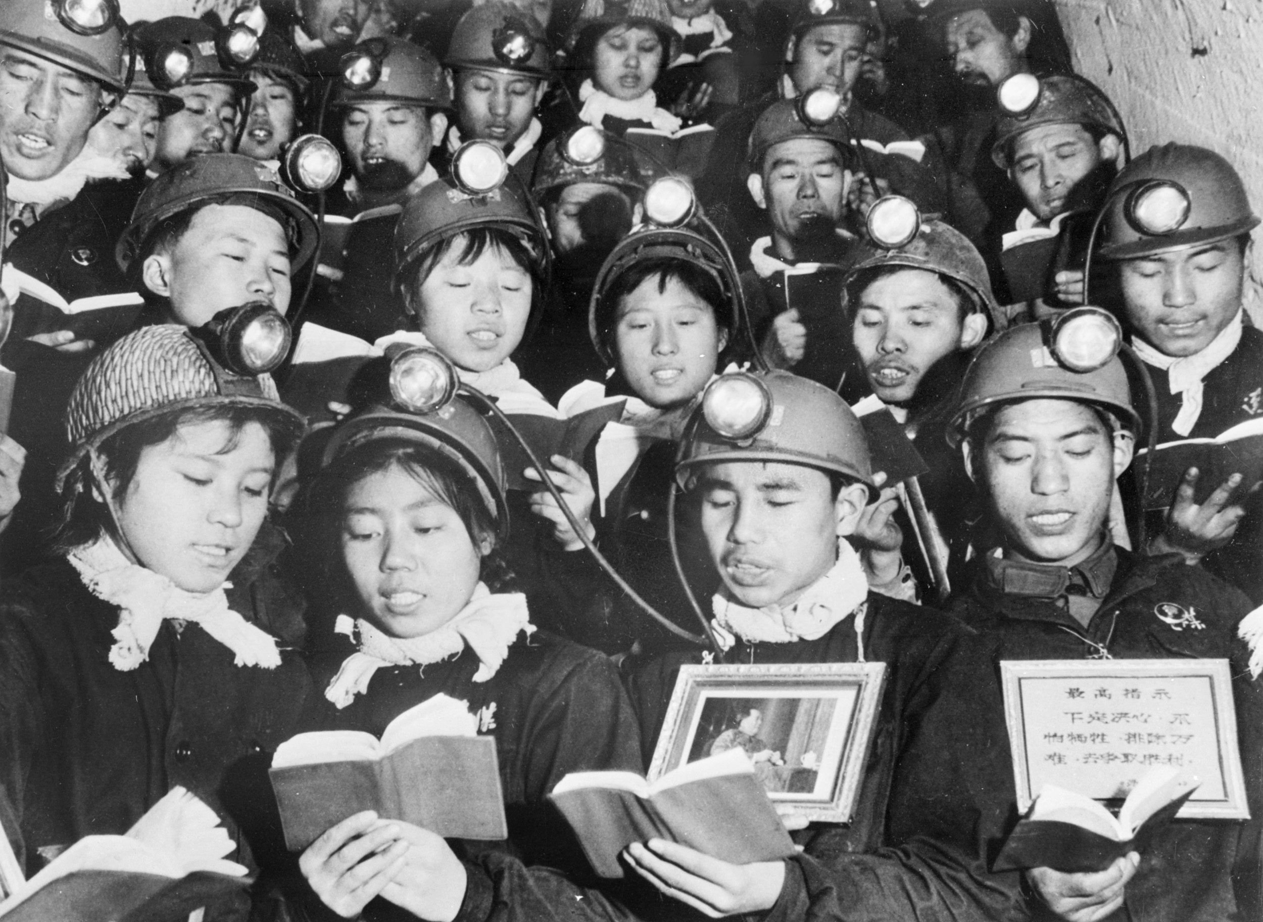 TOPSHOT - A group of male and female coal miners recite 06 September 1968 in Li Se Yuan mine some paragraphs of Mao Zedong "Little Red Book" as they celebrate Mao's "Great Proletarian Cultural Revolution"  (Photo by -/XINHUA/AFP via Getty Images)