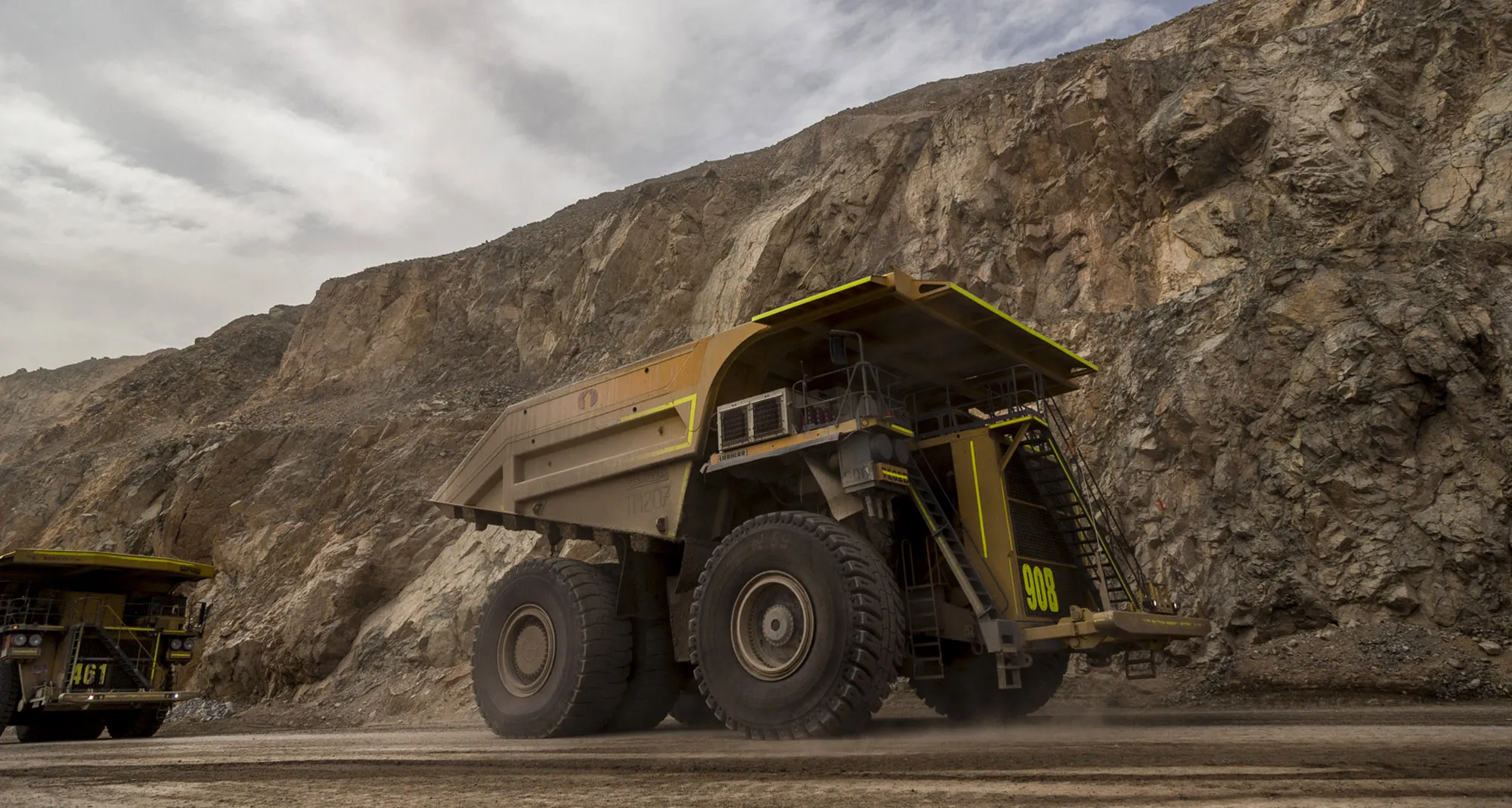 Trucks transport minerals inside an open pit copper mine near Calama, Chile.