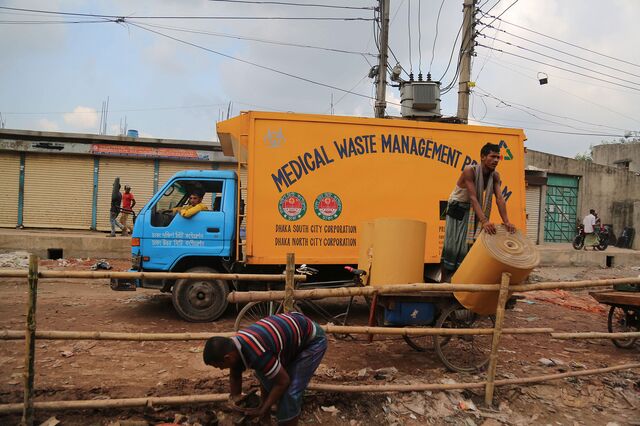 A truck collects medical waste near the Matuail Sanitary Landfill in Dhaka.