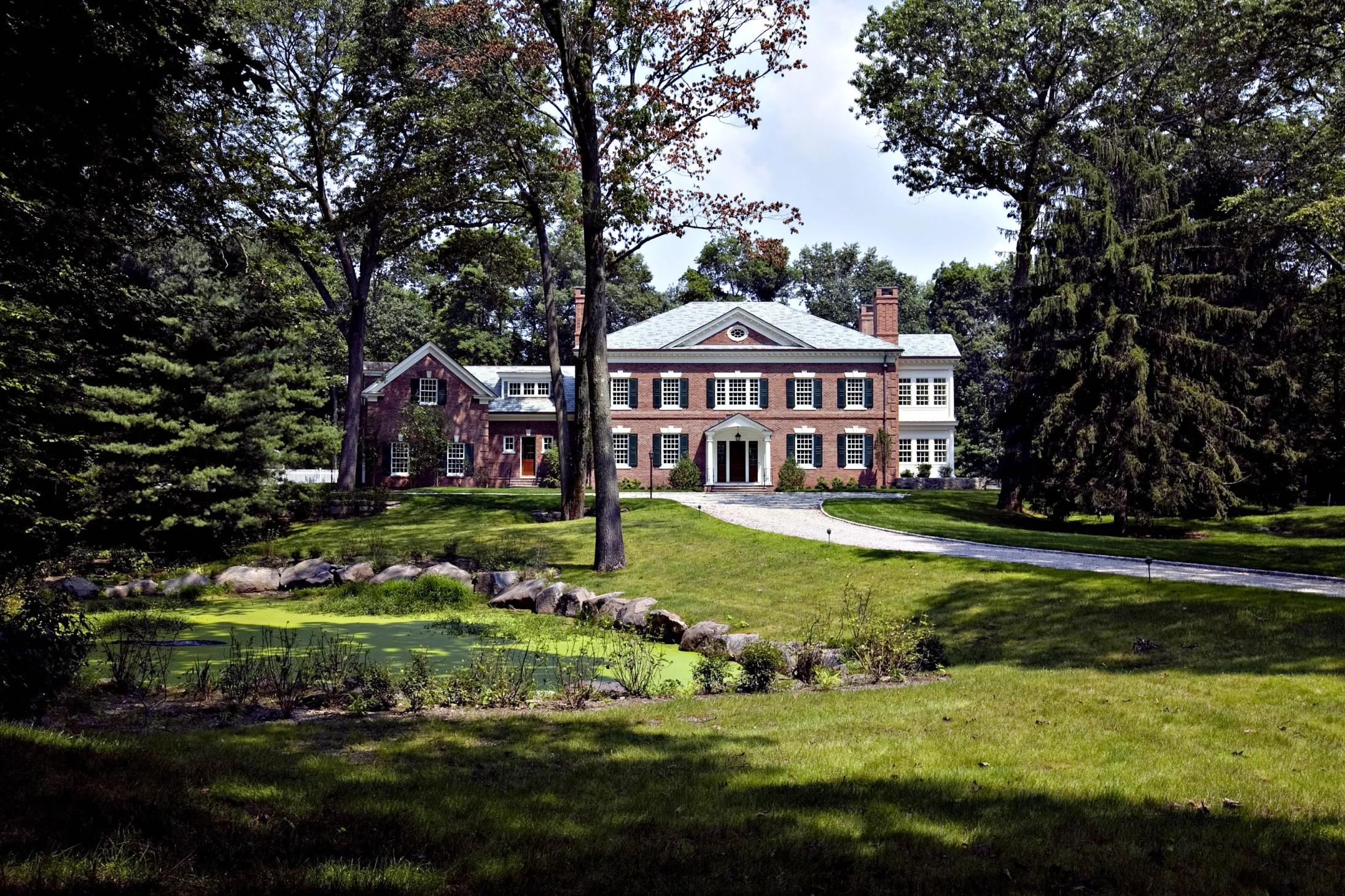 Trees stand around a spec home at 38 French Road in Greenwich, Connecticut, U.S., on Monday, Aug. 17, 2009. Greenwich homeowners saddled with the worst sales market in a 30 years century are turning to the rental market. The number of single-family properties for rent in this suburb an hour's drive from Manhattan climbed more than six-fold this year as sales dried up.