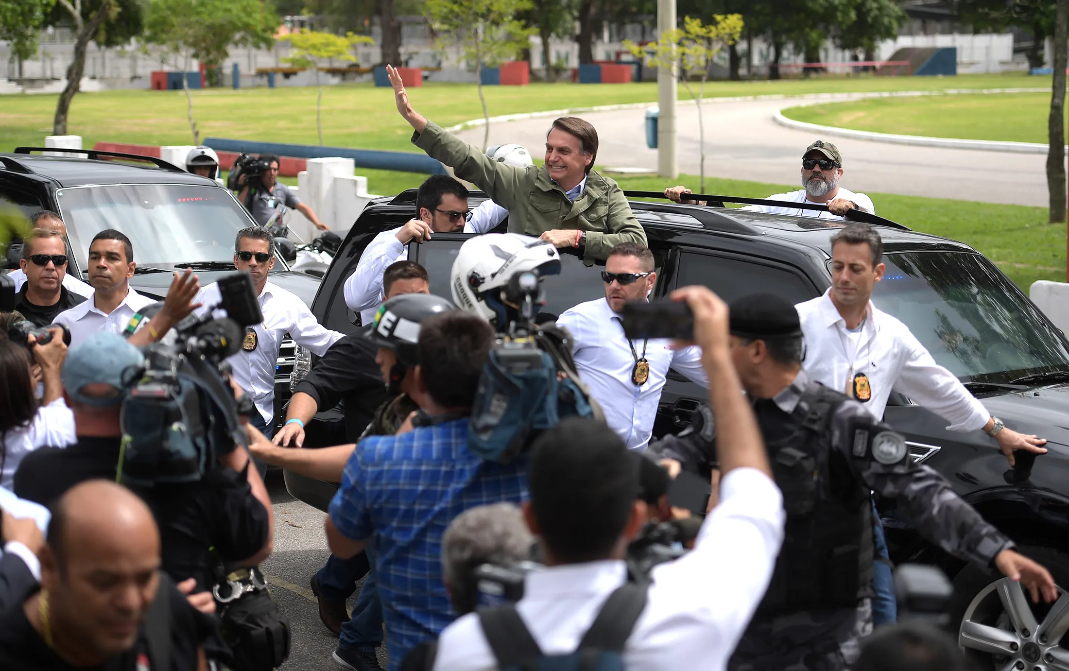 Jair Bolsonaro waves to supporters on Sunday.