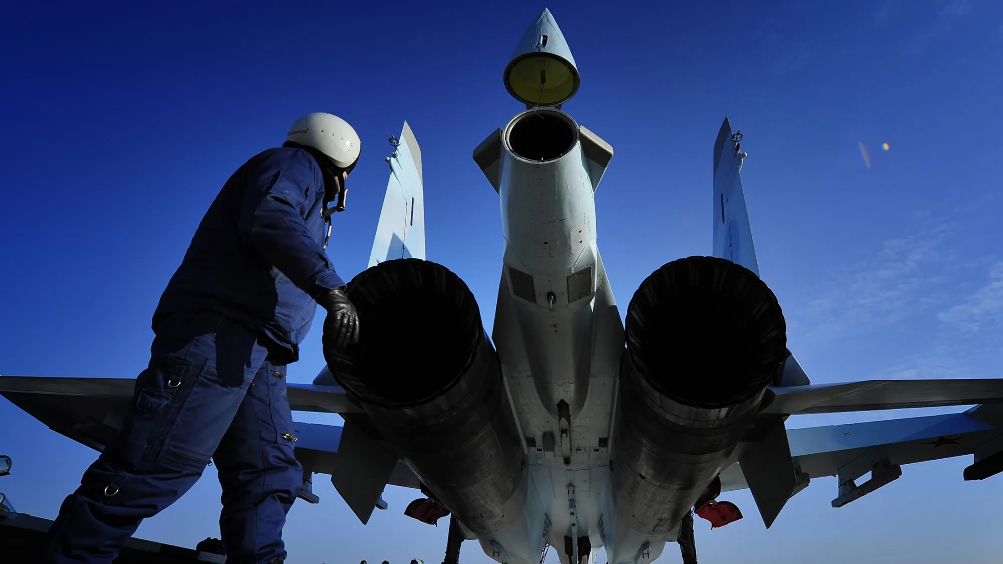 A Russian Airforce pilot outside a Sukhoi Su-35C fighter jet during a flight at Tsentralnaya Uglovaya Air Field.
