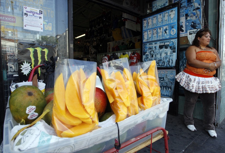 A street vendor sells fruit on Thursday, Sept. 9, 2010, in Los Angeles.