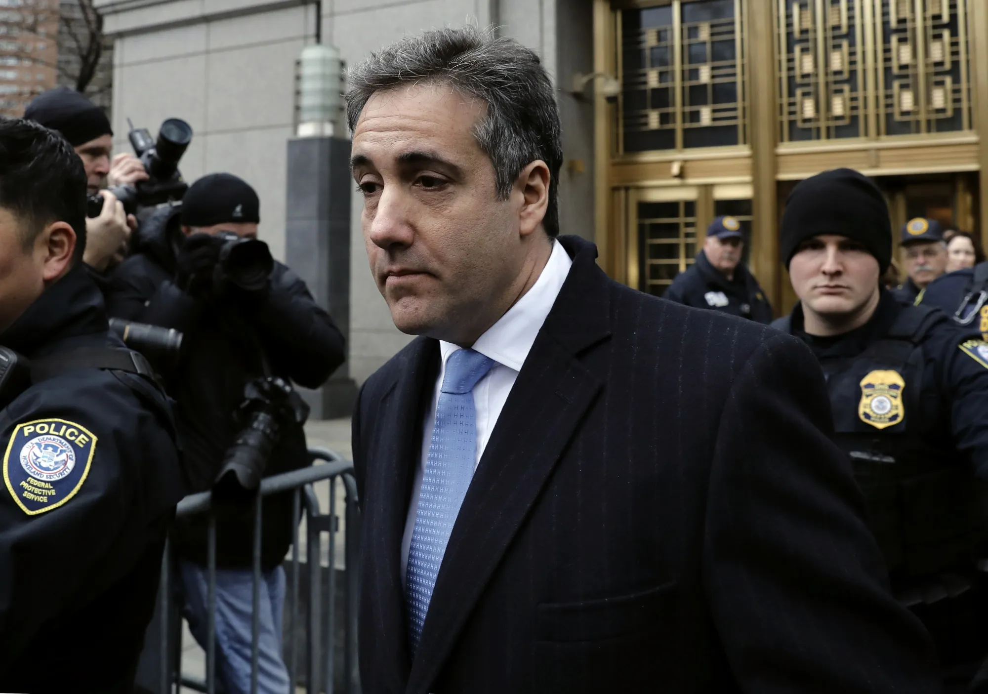 Michael Cohen exits federal court in New York on Dec. 12.