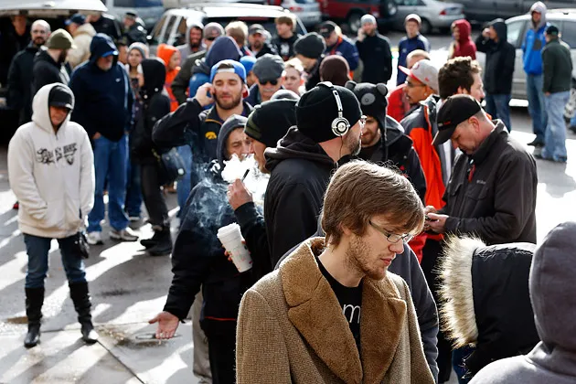 Customers stand in line at 3D Cannabis Center in Denver on Jan. 1