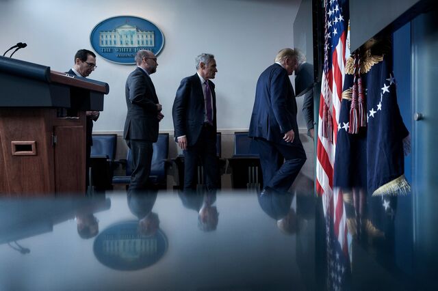 US Secretary of the Treasury Steven Mnuchin, Director of the Office of Management and Budget Russell Vought, member of the coronavirus task force Scott Atlas, and US President Donald Trump leave after a briefing at the White House August 10, 2020, in Washington, DC. 