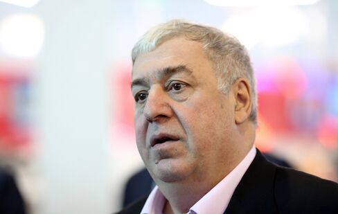 Mikhail Gutseriev, chairman of RussNeft OAO, speaks to an attendee between sessions at the St. Petersburg International Economic Forum (SPIEF) in Saint Petersburg, Russia, on June 19, 2015.