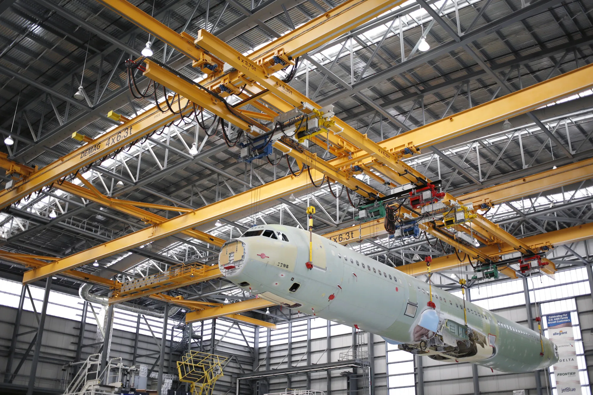 An Airbus SE A321 plane fuselage is lifted with a crane at the company’s final assembly line facility in Mobile, Alabama.