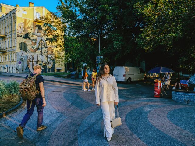 Tetiana Toriya walking outside in a public plaza
