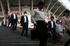 Morning commuters descend a flight of stairs outside Tokyo Station in Tokyo, Japan, on Monday, May 14, 2018. Japan is scheduled to release its first-quarter gross domestic product (GDP) figures on May 16.