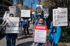 Nurses hold signs during a demonstration for increased personal protection equipment outside Montefiore Hospital in the Bronx.