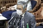 Haruhiko Kuroda, governor of the Bank of Japan (BOJ), wears a protective mask as he speaks during a budget committee session at the lower house of parliament