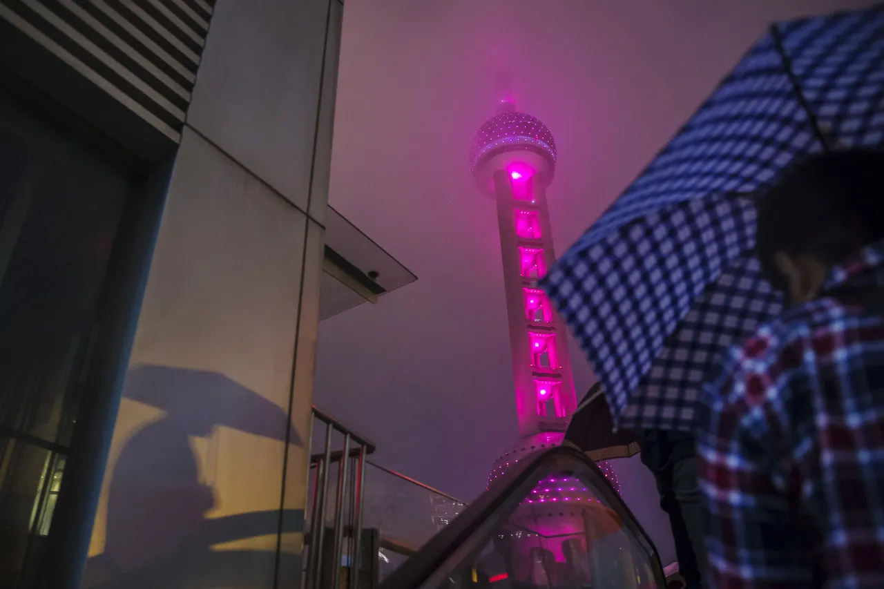 The Oriental Pearl Tower stands illuminated at night in the Lujiazui district of Shanghai.