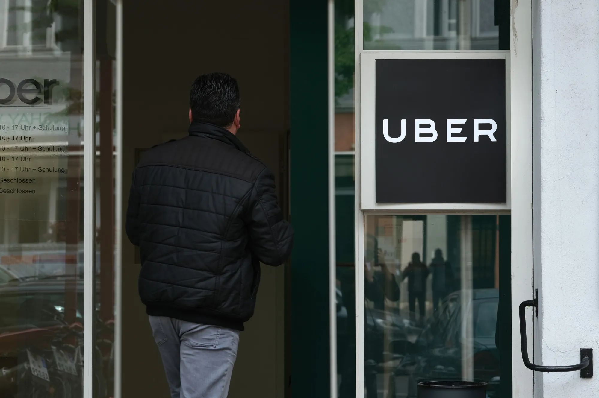 A person enters an Uber drivers registration office&nbsp;in Berlin, Germany.