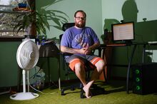 Jeremy Randall at home on his computer.