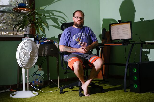 Jeremy Randall at home on his computer.