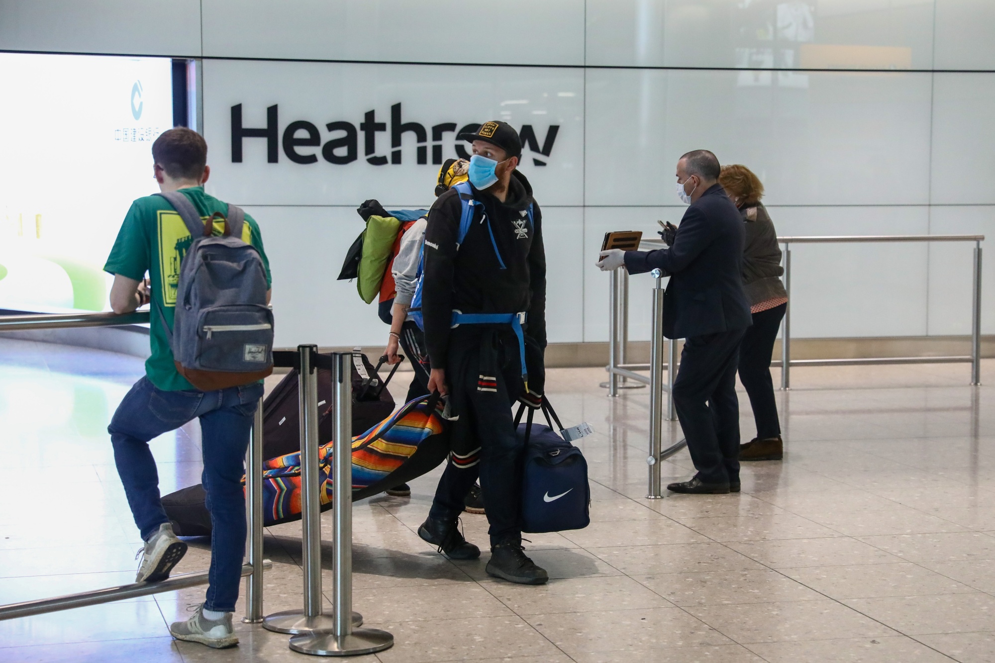 Passengers arrive at London Heathrow airport.