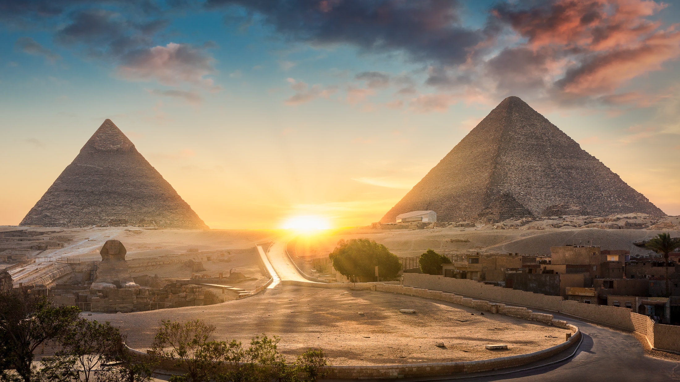 View of The Great Sphinx, Pyramid of Khafre and Great Pyramid of Giza at sunset, Cairo, Giza, Egypt