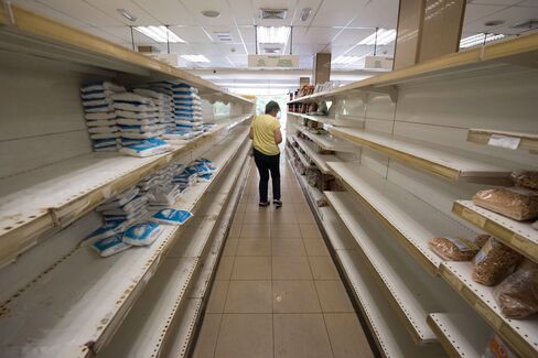 A person shops for groceries at a supermarket in Caracas on July 25.