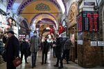 Customers wait outside a currency exchange agency near Grand Bazaar in Istanbul, on Dec. 2.