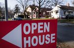 An &quot;Open House&quot; sign is displayed in the front yard of a home for sale in Columbus, Ohio, U.S.