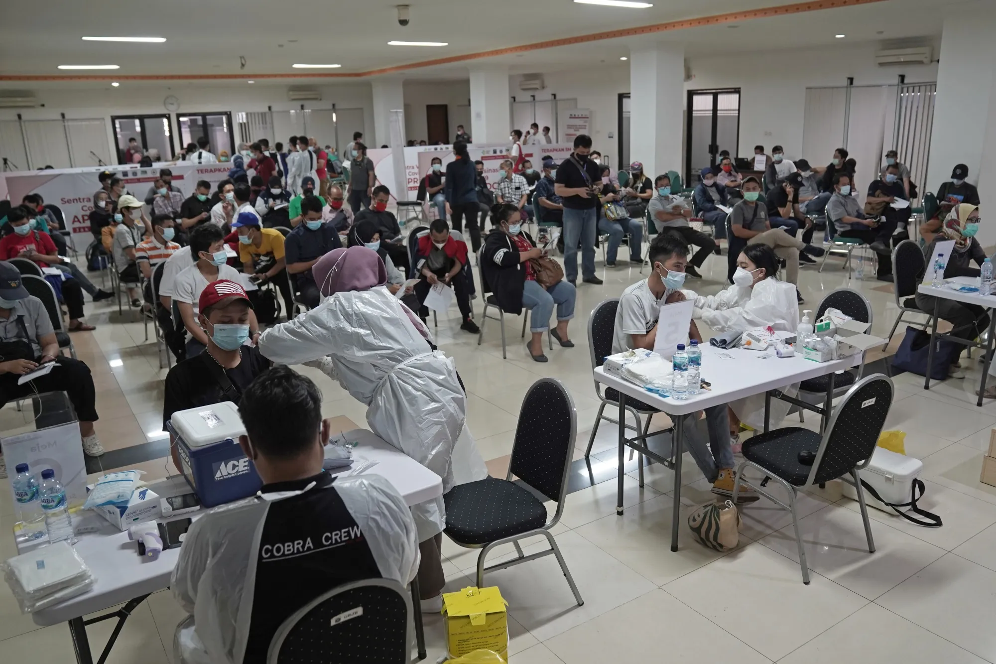 Healthcare workers administer a dose of a Covid-19 vaccine&nbsp;in Jakarta.