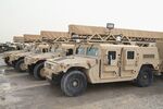 Humvees sit at Kandahar Airfield near Kandahar, Afghanistan, on March 8, 2014
