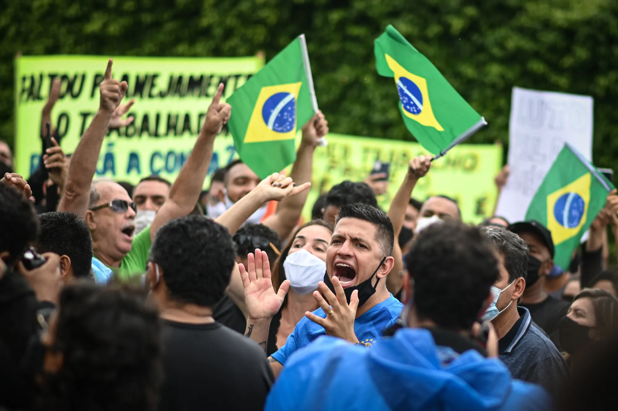 Demonstrators gather during a protest against the lockdown in front of the the home of Ibaneis Rocha, governor of the Federal District, in Brasilia, Brazil, on Sunday, Feb. 28, 2021.