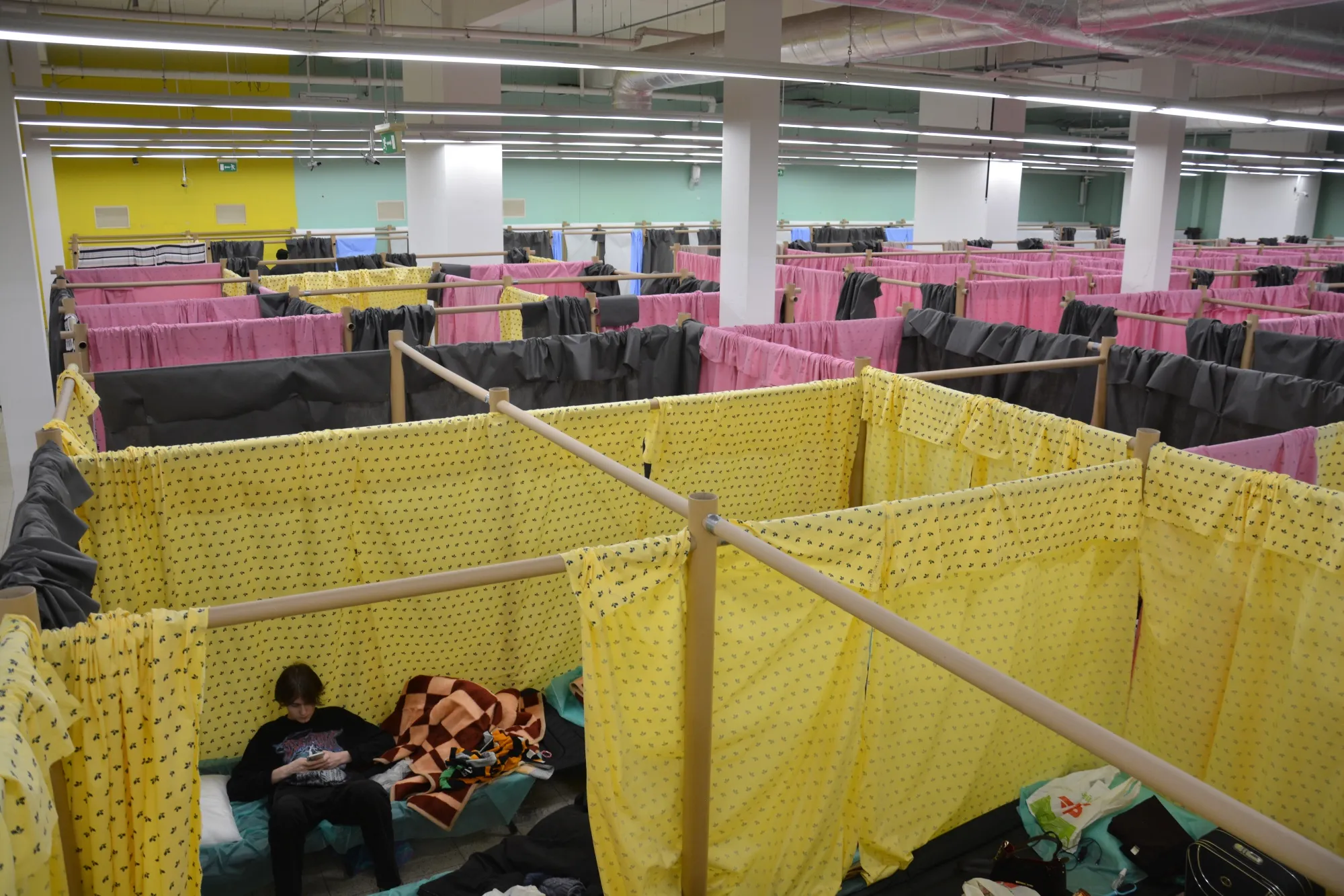 Shigeru Ban’s paper partition system turned a former supermarket into a refugee center in Chełm, Poland.