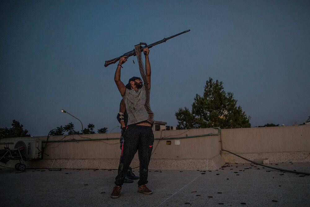 A fighter with Libya's Government of National Accord fires his weapon during clashes with the forces of Khalifa Haftar on the Al-Yarmouk frontline inTripoli on Aug. 22.