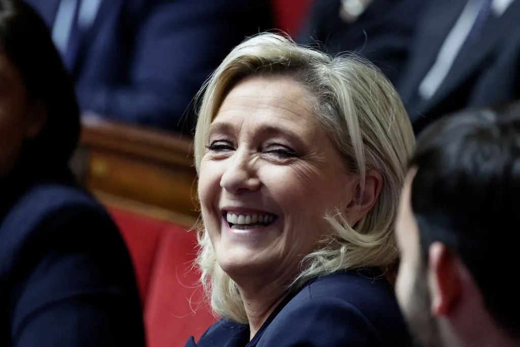 Marine Le Pen is smiling now.